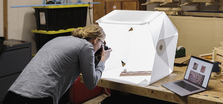 A photographer using a lightbox