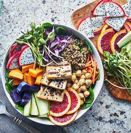 Colorful food image of a grilled tofu salad with dragonfruit and blood oranges