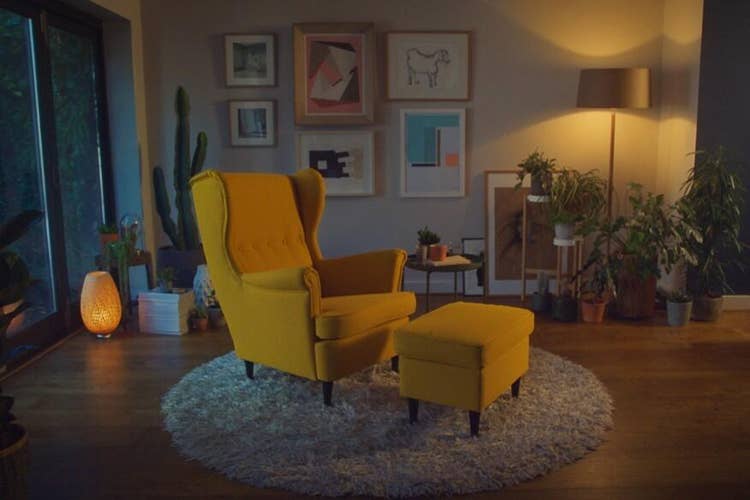 A yellow chair and ottoman in a living room Description automatically generated