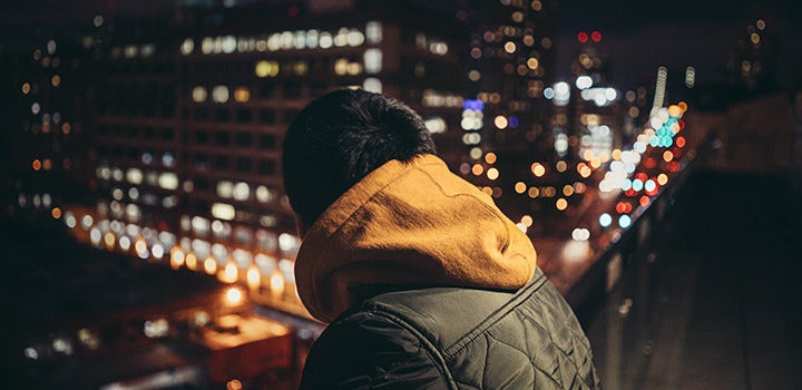 Man in the city at night with a bokeh background.