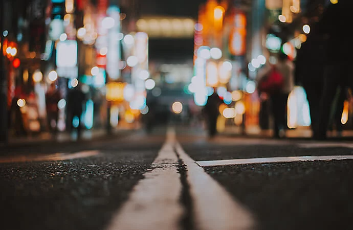 Cracked surface of a city road captured at night