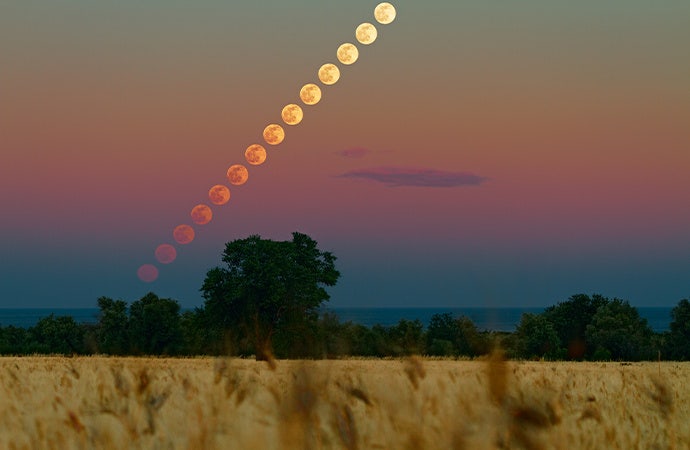 Time-lapse astronomy photo of the moon traveling across the sky.