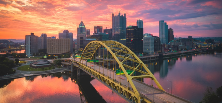 A photo of a bridge connecting to a city edited with HDR software