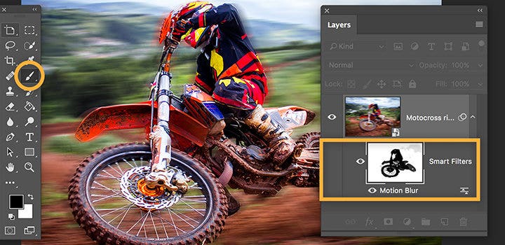 Panning photo of dirt bike and rider being edited in Photoshop with motion blur tools highlighted.