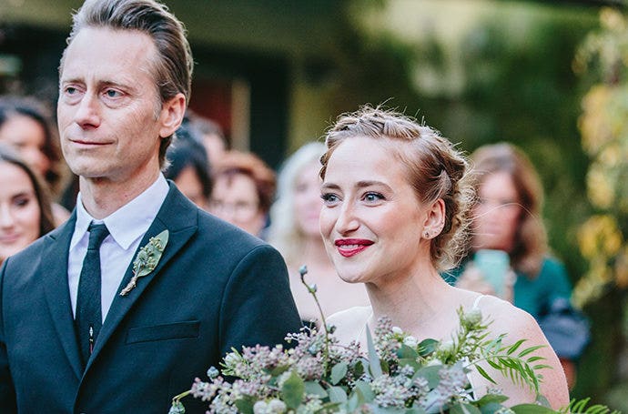 Creatively using focal range to capture a father walking his daughter down the aisle