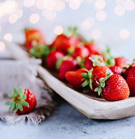 Shallow depth of field photo of strawberries on a plate.