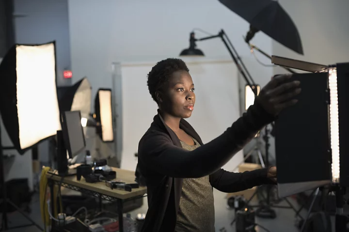 A person setting up lighting equipment for a portrait photoshoot