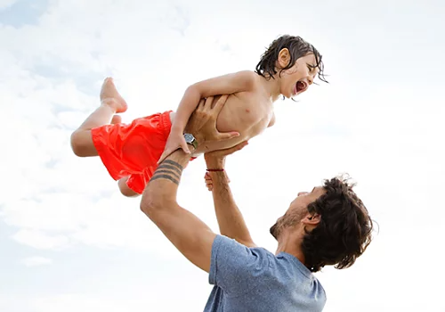 A photo of a father and son playing.