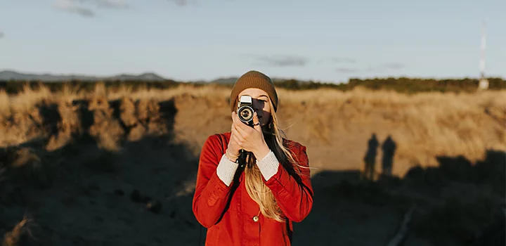 Candid photo of a person holding their camera in-front of their face