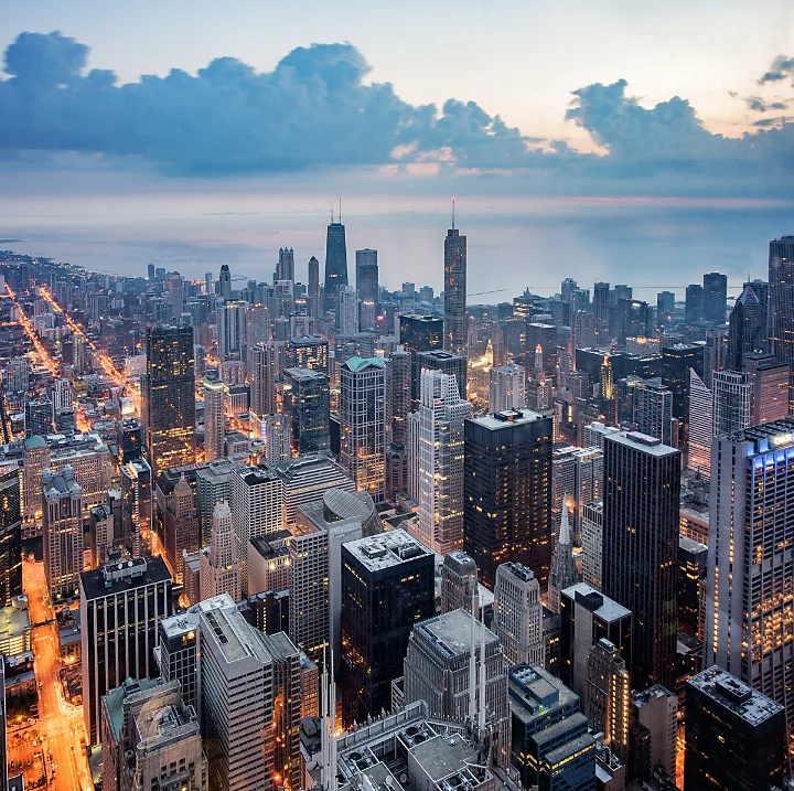 The bright blue haze of a cityscape captured from above as dusk approaches