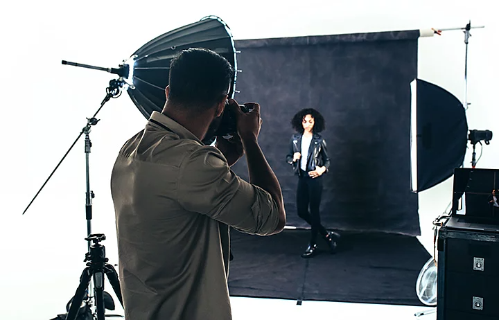 A photographer shooting black-and-white portrait images in their photography studio