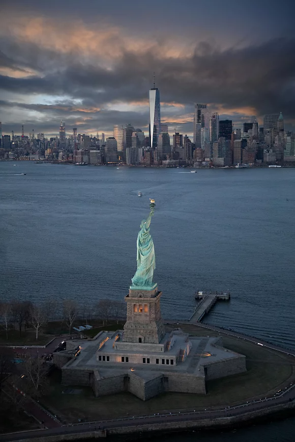 The back of the Statue of Liberty captured from a bird's-eye view with Manhattan in the background