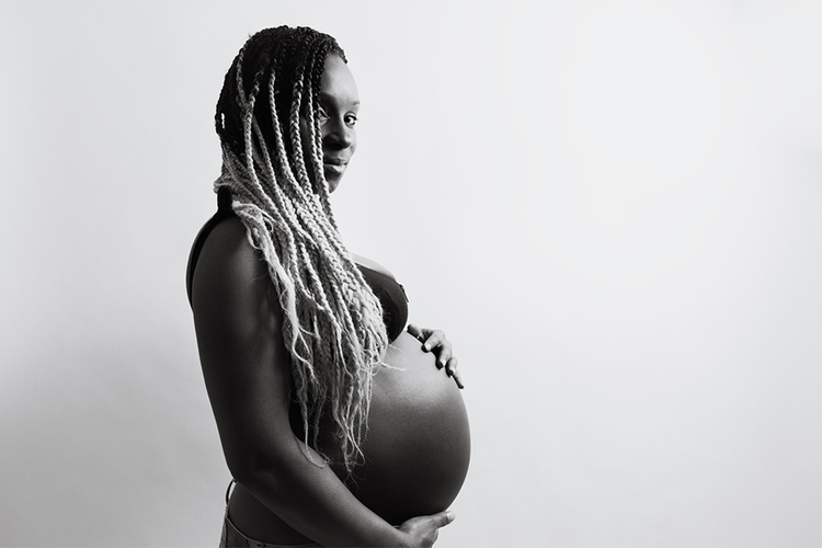 Black-and-white maternity photo of a pregnant parent