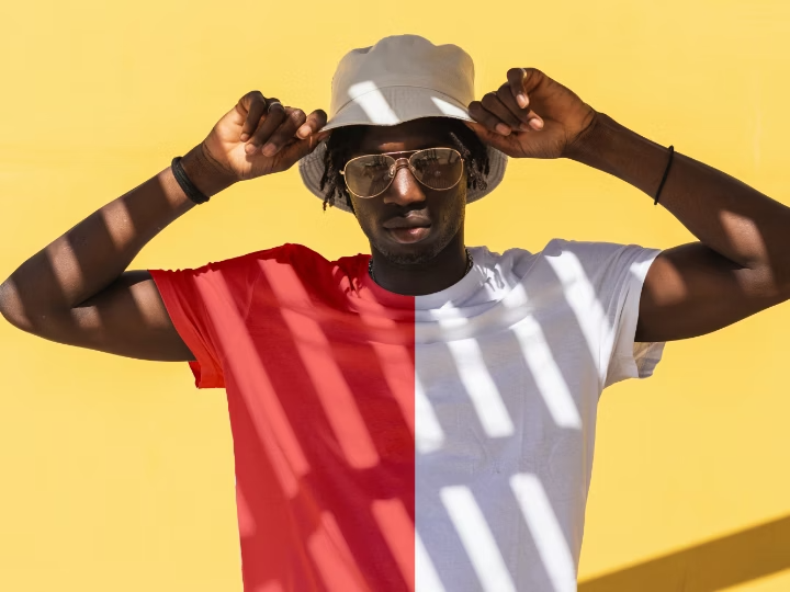 Person with the color of their shirt changed in Photoshop, with one half of the shirt orange and the other half white.