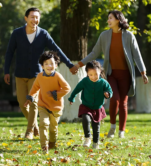 A photo of a family walking together at a park.