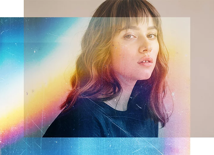 A rainbow-colored blending overlay effect is partially placed on a person's portrait