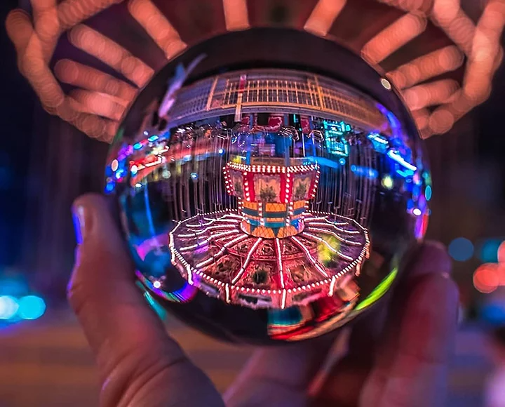 A merry-go-round reflecting in a lensball