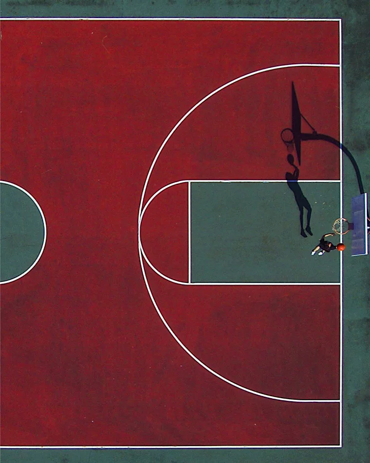 An aerial overhead photo of a person about to dunk a basketball in a hoop on a basketball court