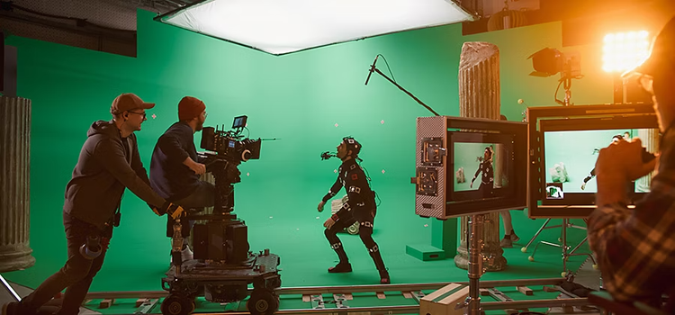 A film crew capturing an actor working in front of a green screen which will be enhanced with a chroma-key