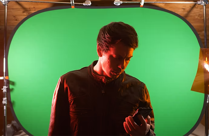 An actor captured against a green screen