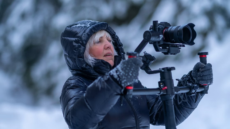 Person filming tracking shot in the snowy forest