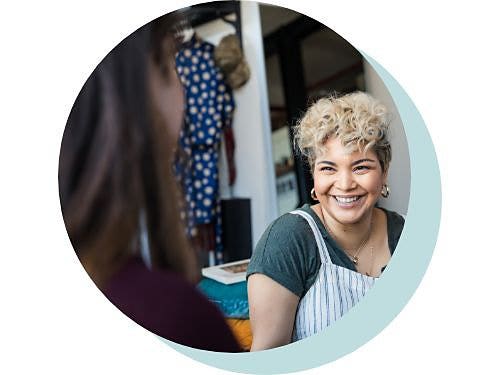 A circular image of an over-the-shoulder shot framing two people talking