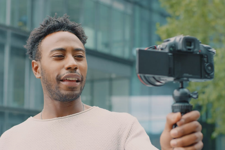 A photo of a person recording a selfie video.