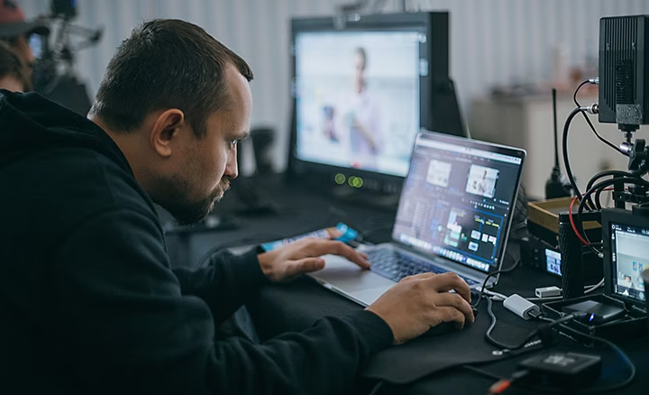 A video editor making adjustments and tweaks to a video using Premiere Pro