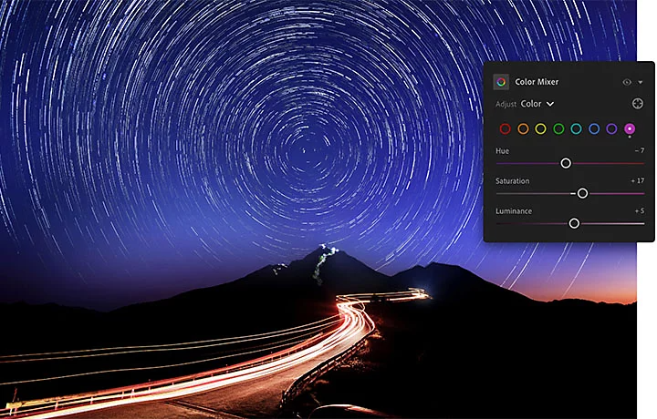 The Adobe Photoshop Lightroom color mixer pane superimposed over an image of a lighted path leading to a mountaintop with star trails behind it