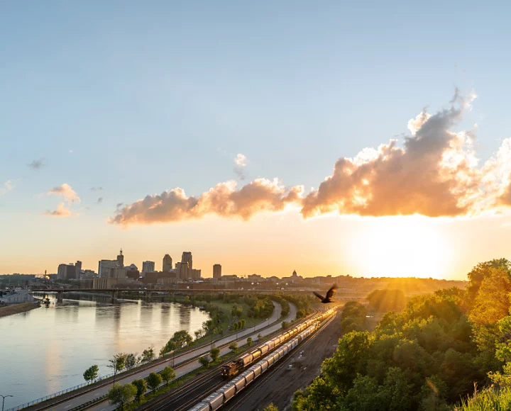 A sunrise next to a city