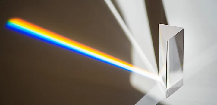 A photo of a prism reflecting a rainbow