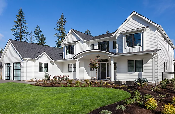 Photo of a house taken in the daylight making the windows appear dark