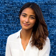 A person smiling in front of a blue screen Description automatically generated