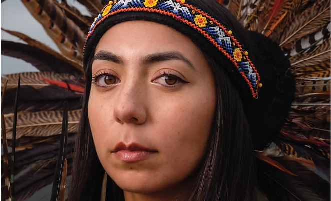 Closeup of Natalie Contreras wearing ceremonial headdress.