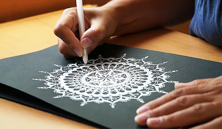 Mujer dibujando un mandala