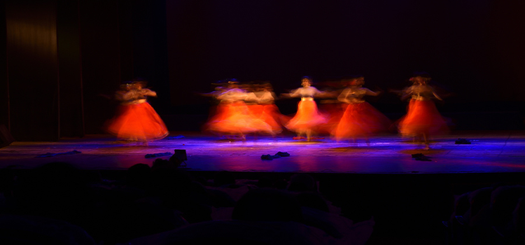 Slow shutter speed image of ballet dancers performing on stage