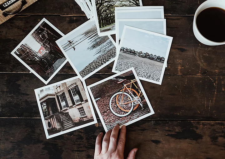 A bunch of developed film photos scattered on a table