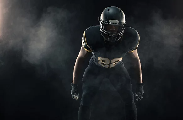 A dramatic studio photo of a football player.