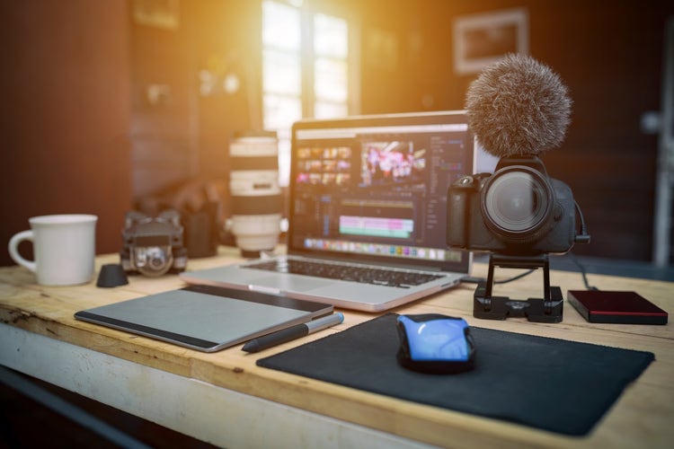 How to start a vlog: A camera and microphone sitting next to a laptop