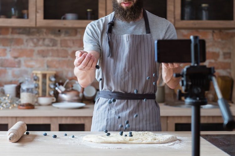 Content creator: Food blogger in apron shooting a new baking video