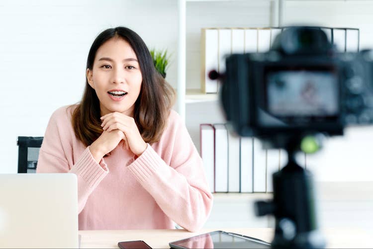 Lady in pink taking a video of herself