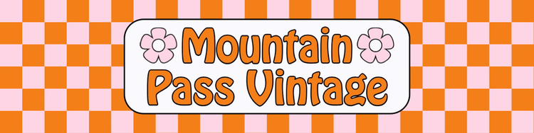 An Etsy banner for Mountain Pass Vintage with their logo against a pink and orange checkered background