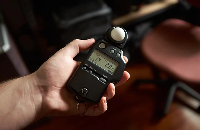 A person holding a light meter