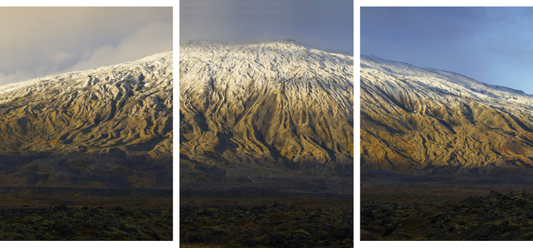 A panorama of a snow-covered mountained split across three separate photo