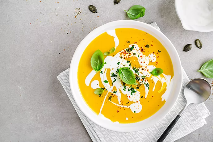 alt="pumpkin-creamy-soup-served-in-bowl"