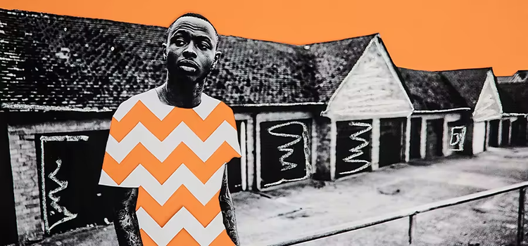 Black and white photo with only the colour orange of a person standing in front of a house