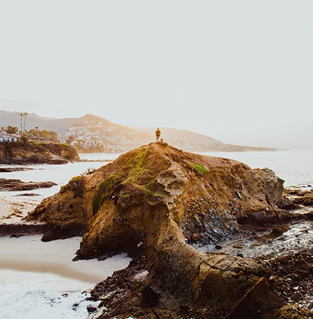 Use landscape photography techniques to take photos of subjects on a distant hilltop