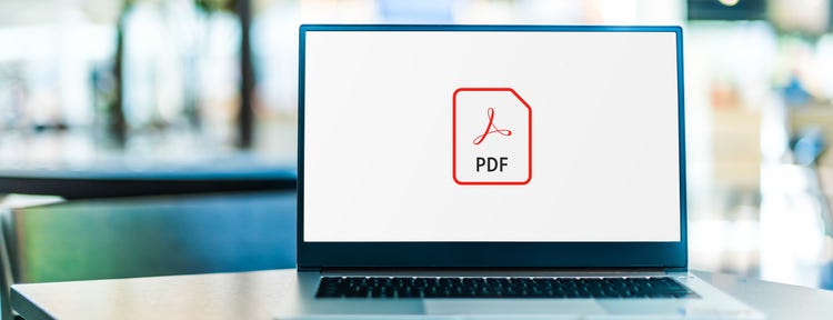 Laptop computer displaying the logo of an Adobe Acrobat PDF file.