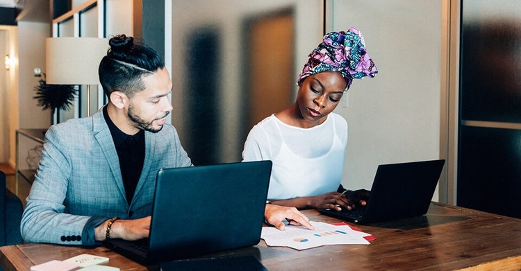 Business colleagues reviewing printed data as they develop their sales workflow