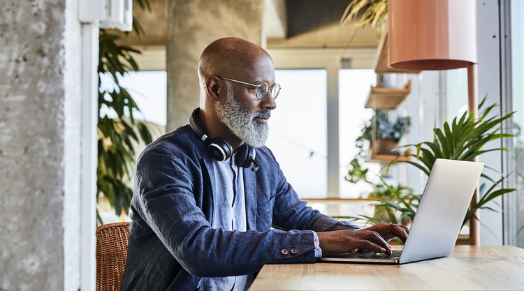 A business owner sitting at their desk reviewing an operating agreement for their business